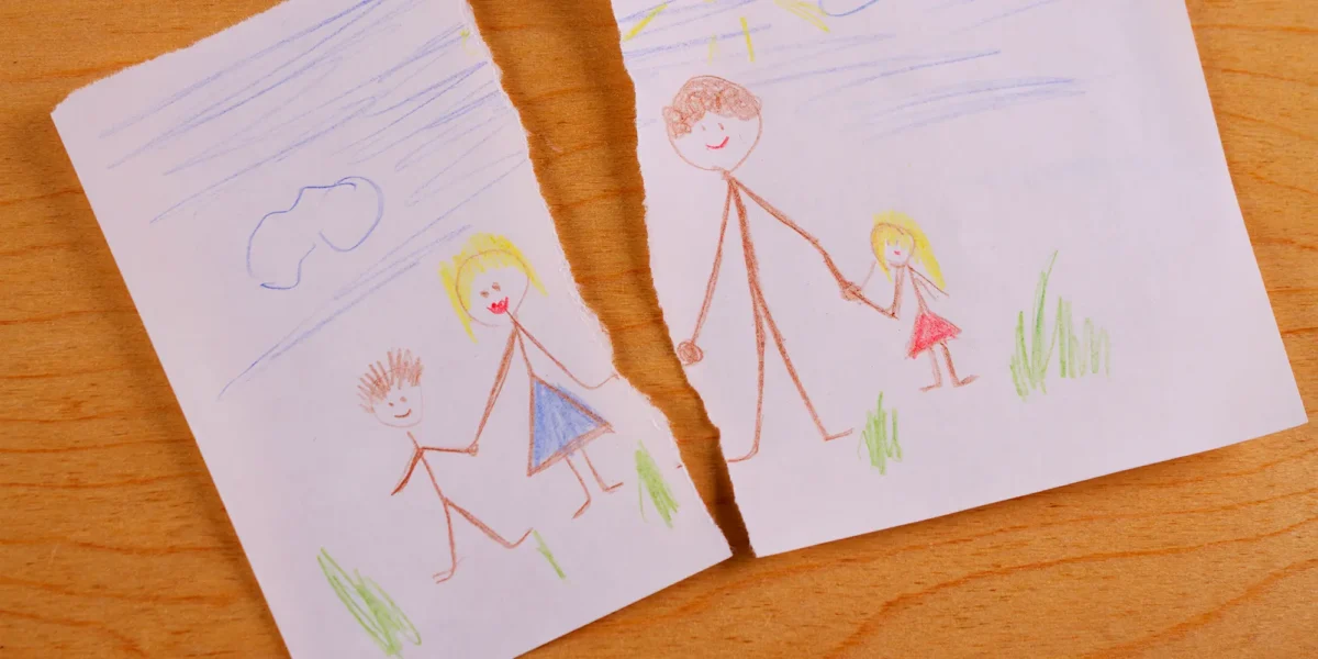 crayon drawing of family that is torn in half